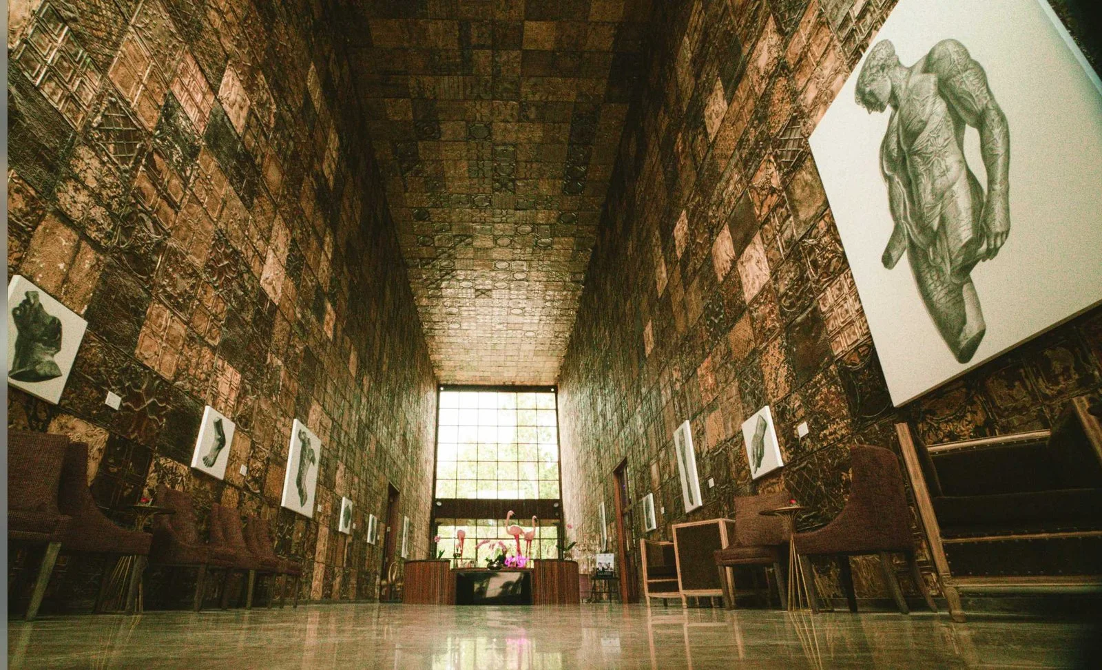 Tall gallery interior at the Bali property, lined with artwork